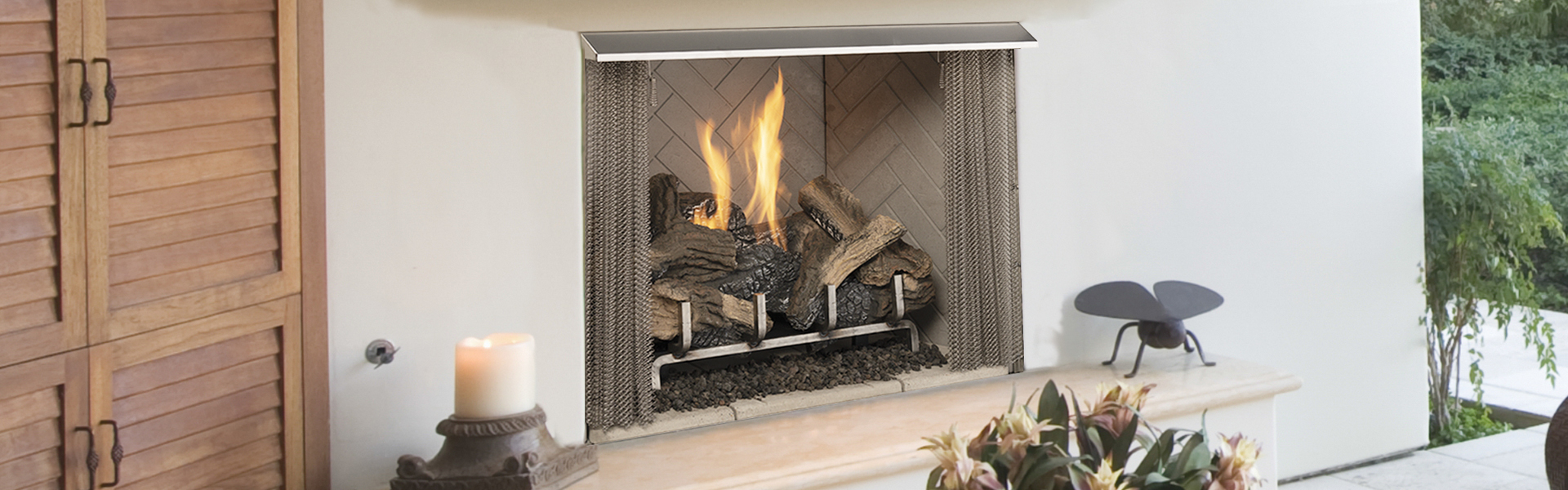 Superior VRE3200 vent-free outdoor gas fireplace installed in a covered outdoor room with stone surround and wooden shutters